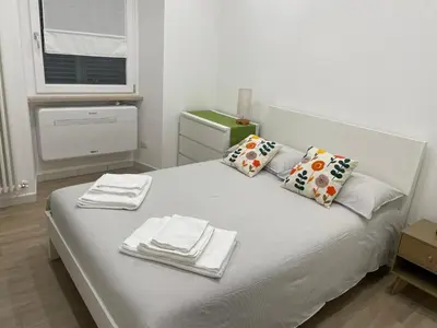 a white bed with towels and napkins on it at St Peter Family Stay in Rome