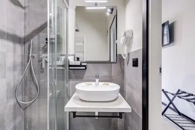 a bathroom with a sink and a shower at VIVILO COLLECTION - Muggia 21 Suites in Rome