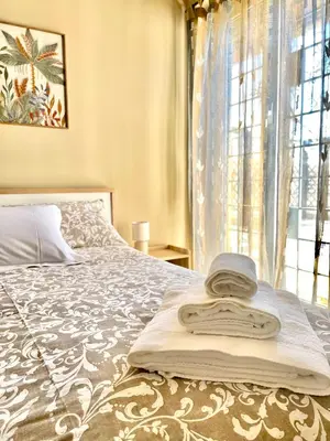 a bedroom with a bed with a hat on it at RomaCentum Apartment Aurelio in Rome