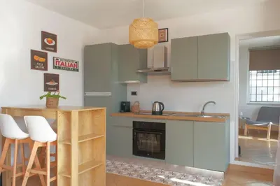 a kitchen with a counter and a stove top oven at RomaCentum Apartment Aurelio in Rome