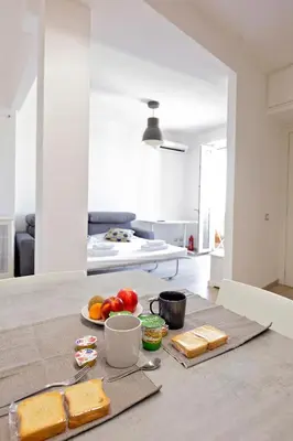 a table with a plate of bread and fruit on it at Ion Apartment in Rome