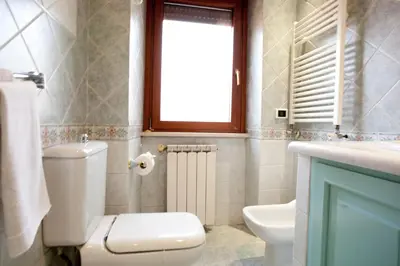 a bathroom with a toilet and a sink and a window at Francesca e Anita in Rome