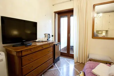 a living room with a television on a dresser at Francesca e Anita in Rome