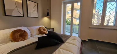 a living room with a couch with pillows on it at Nox Romana - Vatican - Luxury Flat with Terrace in Rome