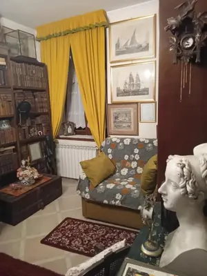 a living room with a bed and a statue in a room at Loft Appia Antica Donna Eugenia in Rome