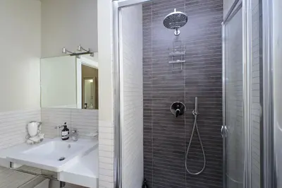 a bathroom with a shower and a sink at Vatican Claudia's apartment in Rome