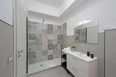 a bathroom with a shower and a sink and a mirror at St Peter Sanctuary Retreat Spacious 120 mq Apartment Vatican in Rome
