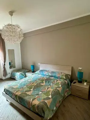 a bedroom with a large bed and a chandelier at Residenza Cenci in Rome