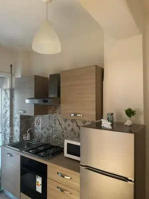a kitchen with a refrigerator and a stove top oven at Residenza Cenci in Rome