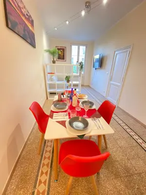 a dining room with a table and red chairs at Red House Trastevere San Pietro Bambin Gesú Sant Onofrio Appartamento Roma in Rome