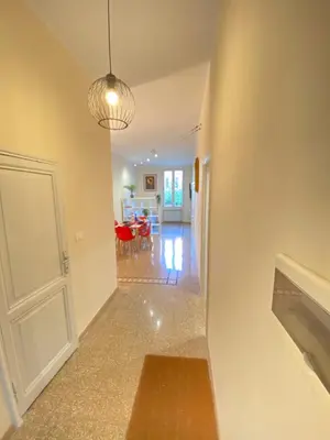 a hallway with a door and a living room at Red House Trastevere San Pietro Bambin Gesú Sant Onofrio Appartamento Roma in Rome