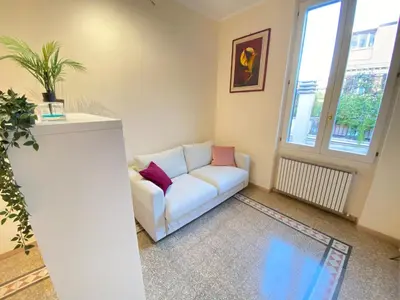 a living room with a couch and a window at Red House Trastevere San Pietro Bambin Gesú Sant Onofrio Appartamento Roma in Rome
