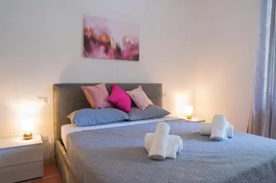 a bedroom with a bed with two white towels on it at Carpegna Sweet House - A few stops from the city centre in Rome