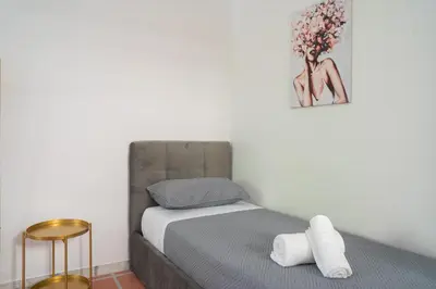 a small bedroom with a bed and a picture on the wall at Carpegna Sweet House - A few stops from the city centre in Rome
