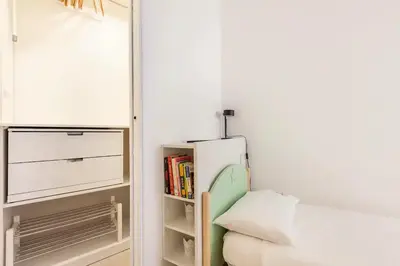 a small room with a bed and a book shelf at Vatican Flat in Rome