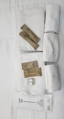 a group of towels and a bottle of perfume at Rome Jubilee Stays in Rome