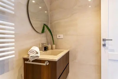 a bathroom with a sink and a mirror at iFlat Luxury Penthouse near Trevi Fountain in Rome