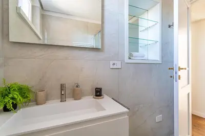 a bathroom with a white sink and a mirror at iFlat Luxury Penthouse near Trevi Fountain in Rome
