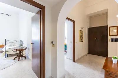 a hallway with a door leading to a dining room at Pietroburgo by Rental in Rome in Rome