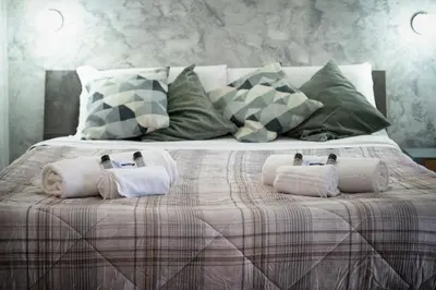 a bed with towels and pillows on top of it at Magenta Collection Terrione 19 in Rome