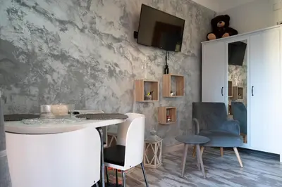 a dining room with a white table and chairs at Magenta Collection Terrione 19 in Rome