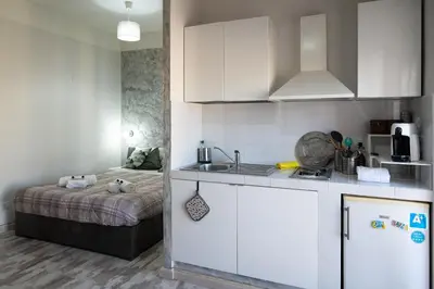 a kitchen with a sink and a bed in a room at Magenta Collection Terrione 19 in Rome