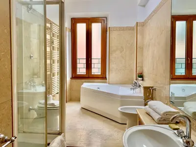 a bathroom with a tub and a toilet and a sink at DaliTourism - Colosseo Prestige Apartment in Rome
