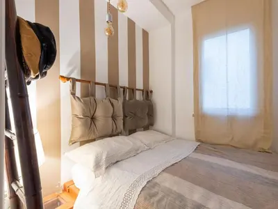 a bedroom with a bed with a striped wall at Apartment Tiziano by Interhome in Rome