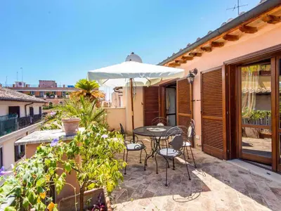 a living room with a couch and a chair at Apartment Charming Terrace by Interhome in Rome
