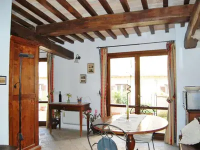 a room with a table and a bed and a wooden cabinet at Apartment Charming Terrace by Interhome in Rome