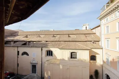 a large white building with a large garage at Charming Minerva - My Extra Home in Rome
