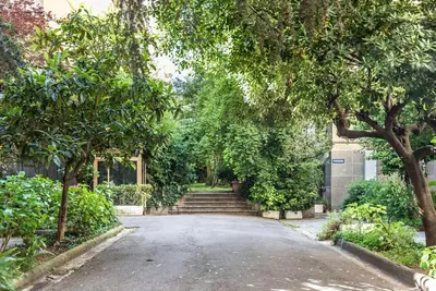 a street with trees and stairs in front of a building at Splendido appartamento a Villa Ada in Rome