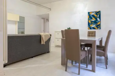 a dining room with a table and a couch at DiTullio18 - Cipro Balduina in Rome
