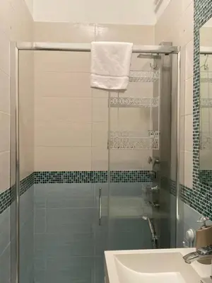 a bathroom with a glass shower and a sink at DiTullio18 - Cipro Balduina in Rome