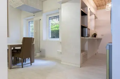 a kitchen and dining room with a table and a window at DiTullio18 - Cipro Balduina in Rome