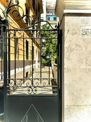 a black gate on a building with a street at Rinascita Vatican Home in Rome