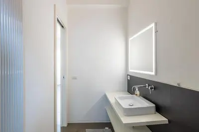 a bathroom with a sink and a mirror at Il Cupolone 3 camere a San Pietro in Rome