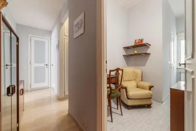 a living room with a chair and a chair at GuestHost - Villa Pamphili & Vaticano Cozy Apartment in Rome