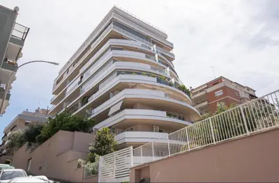 a tall building with balconies in a city at Enchanting Garden Retreat in Rome