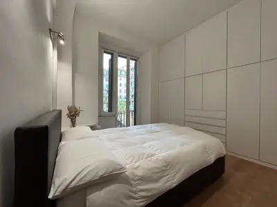 a white bedroom with a large bed in a room at Cozy apartment- 100 meters from Vatican in Rome