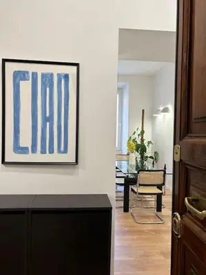 a living room with a painting on the wall at Cozy apartment- 100 meters from Vatican in Rome