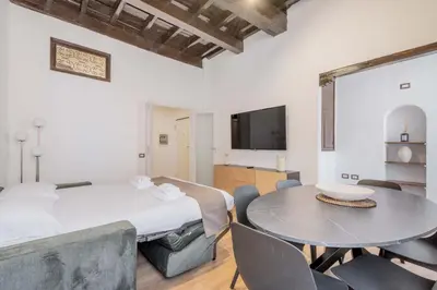 a bedroom with a bed and a table and chairs at Rufina's Home in Rome