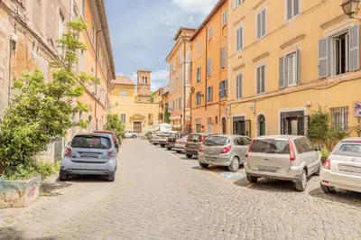 a row of cars parked on a cobblestone street at Rufina's Home in Rome