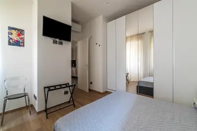 a bedroom with a bed and a tv on a wall at GuestHost - Regina Margherita Suite in Rome