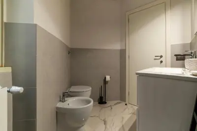 a bathroom with a toilet and a sink at GuestHost - Regina Margherita Suite in Rome