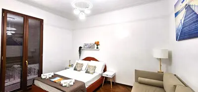 a small bedroom with a bed and a chair at VATICAN ERA Guest House in Rome