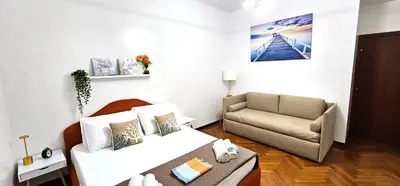a living room with a couch and a chair at VATICAN ERA Guest House in Rome