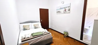a small bedroom with a bed and a mirror at VATICAN ERA Guest House in Rome