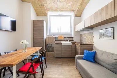 a kitchen and living room with a table and a couch at CASA ELENA, Testaccio in Rome