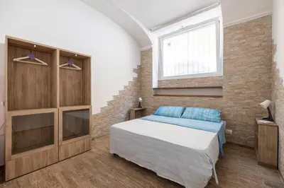 a bedroom with a bed and a brick wall at CASA ELENA, Testaccio in Rome